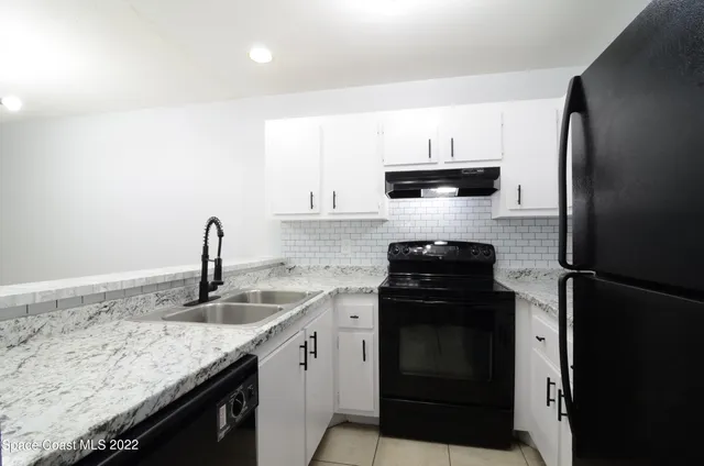 a kitchen with a stove and a refrigerator