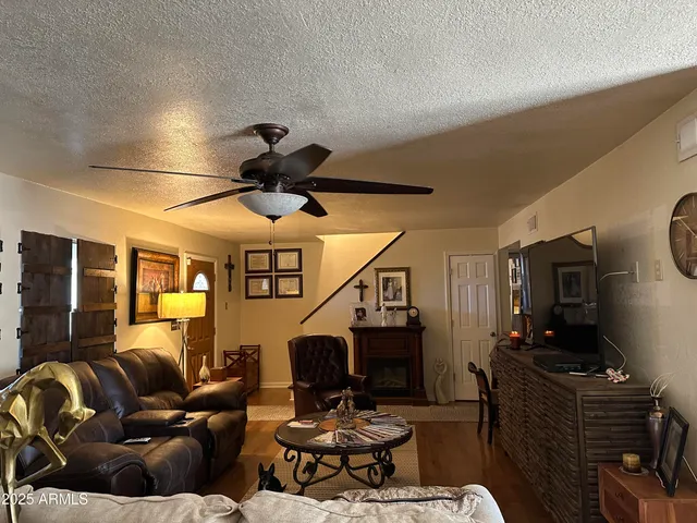 a living room with furniture a rug and a chandelier