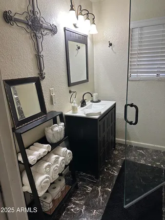 a bathroom with a shower and a sink