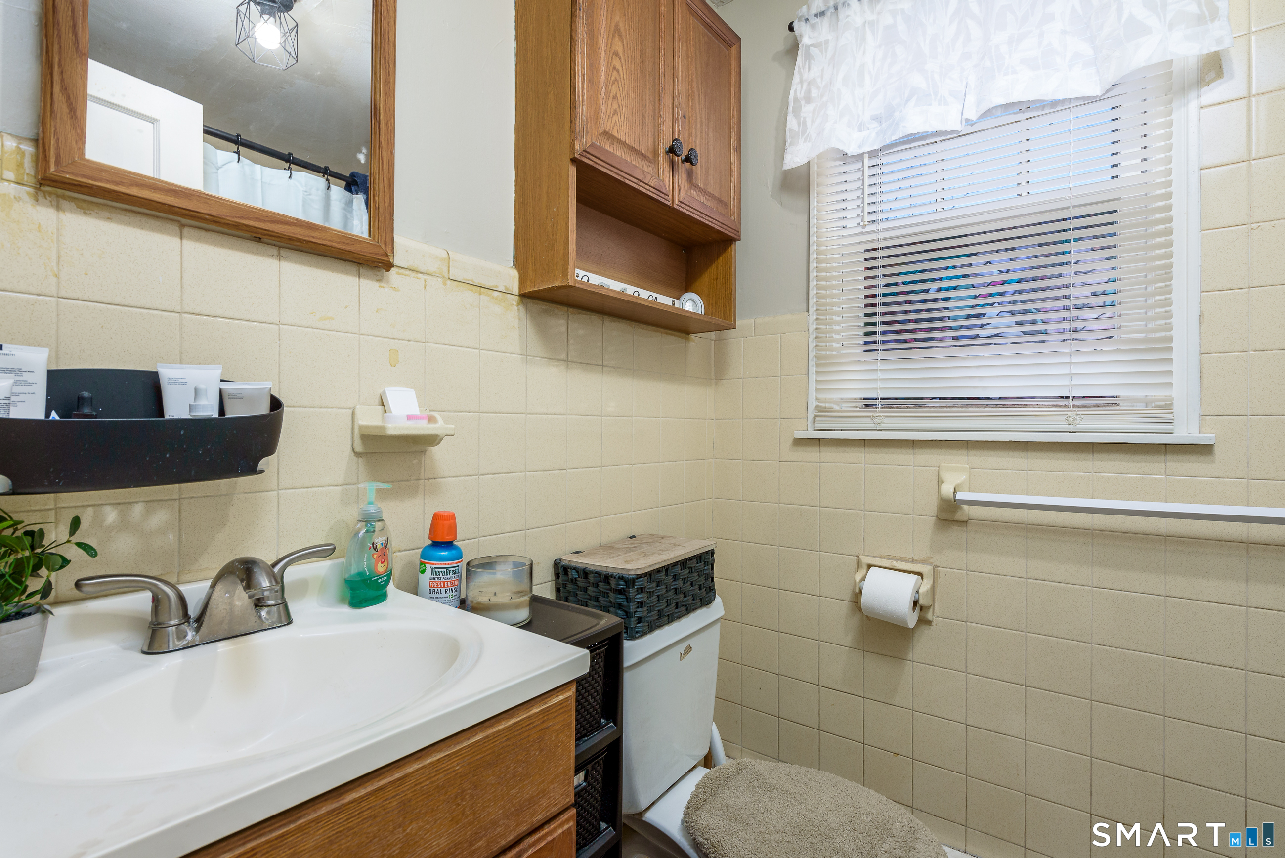 1035 North Worthy Street Windsor, CT 06095 - Photo 14 of 34 a bathroom with a sink and a washing machine