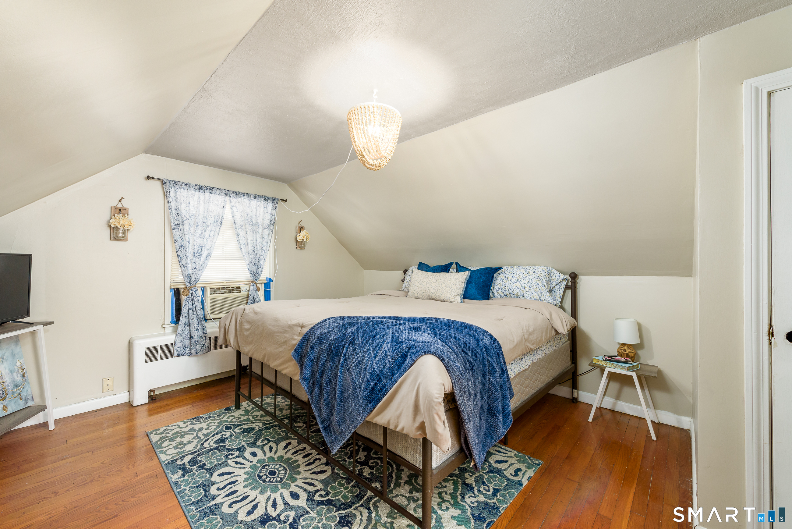 1035 North Worthy Street Windsor, CT 06095 - Photo 21 of 34 a spacious bedroom with a bed and wooden floor