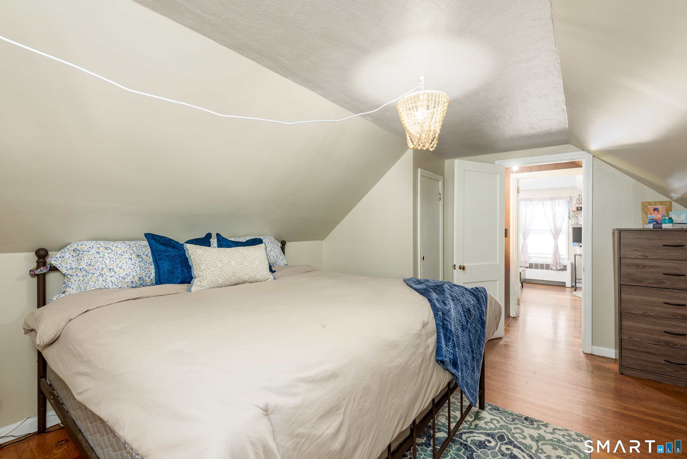 1035 North Worthy Street Windsor, CT 06095 - Photo 22 of 34 a bedroom with a bed and wooden floor