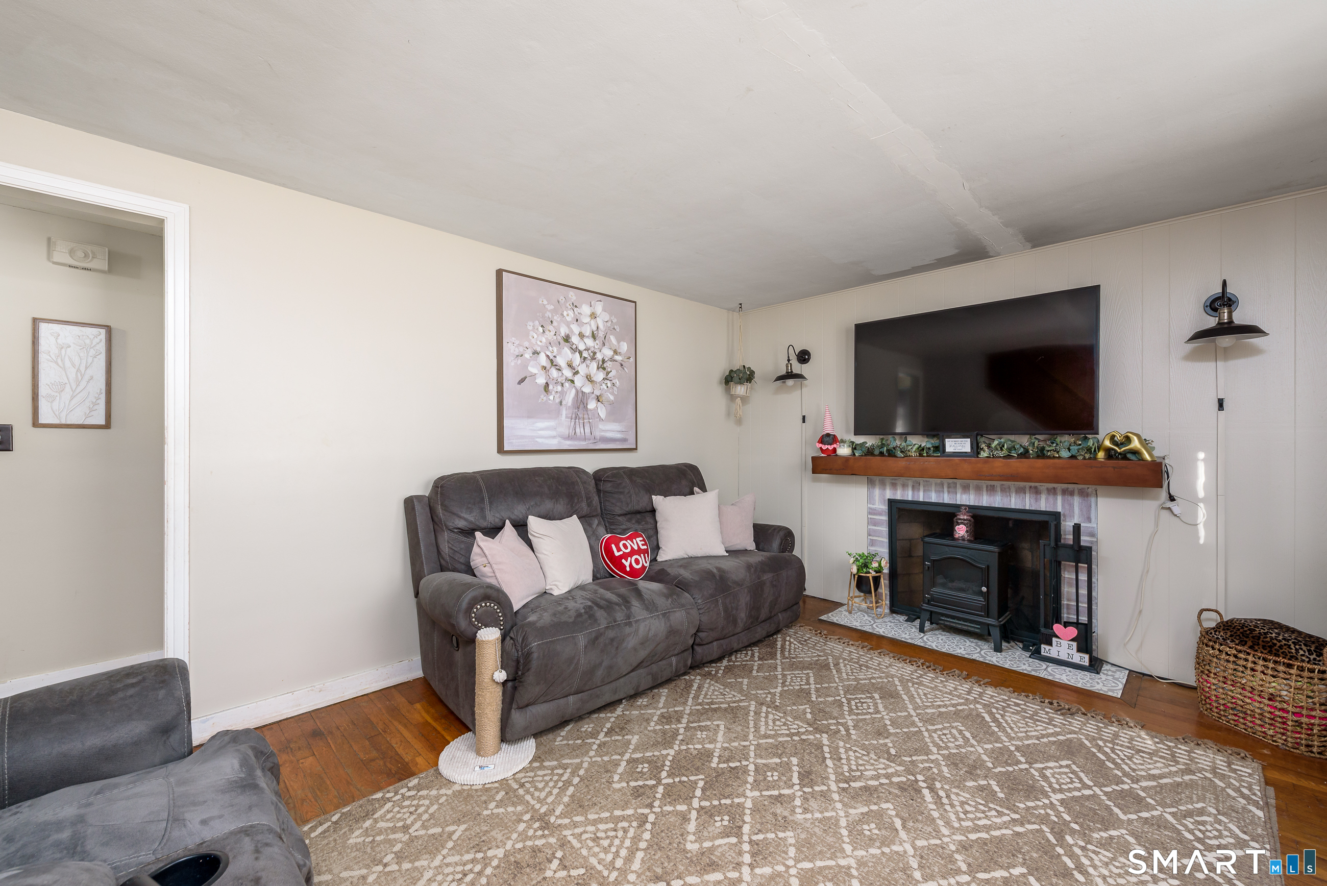 1035 North Worthy Street Windsor, CT 06095 - Photo 4 of 34 a living room with furniture a flat screen tv and a fireplace