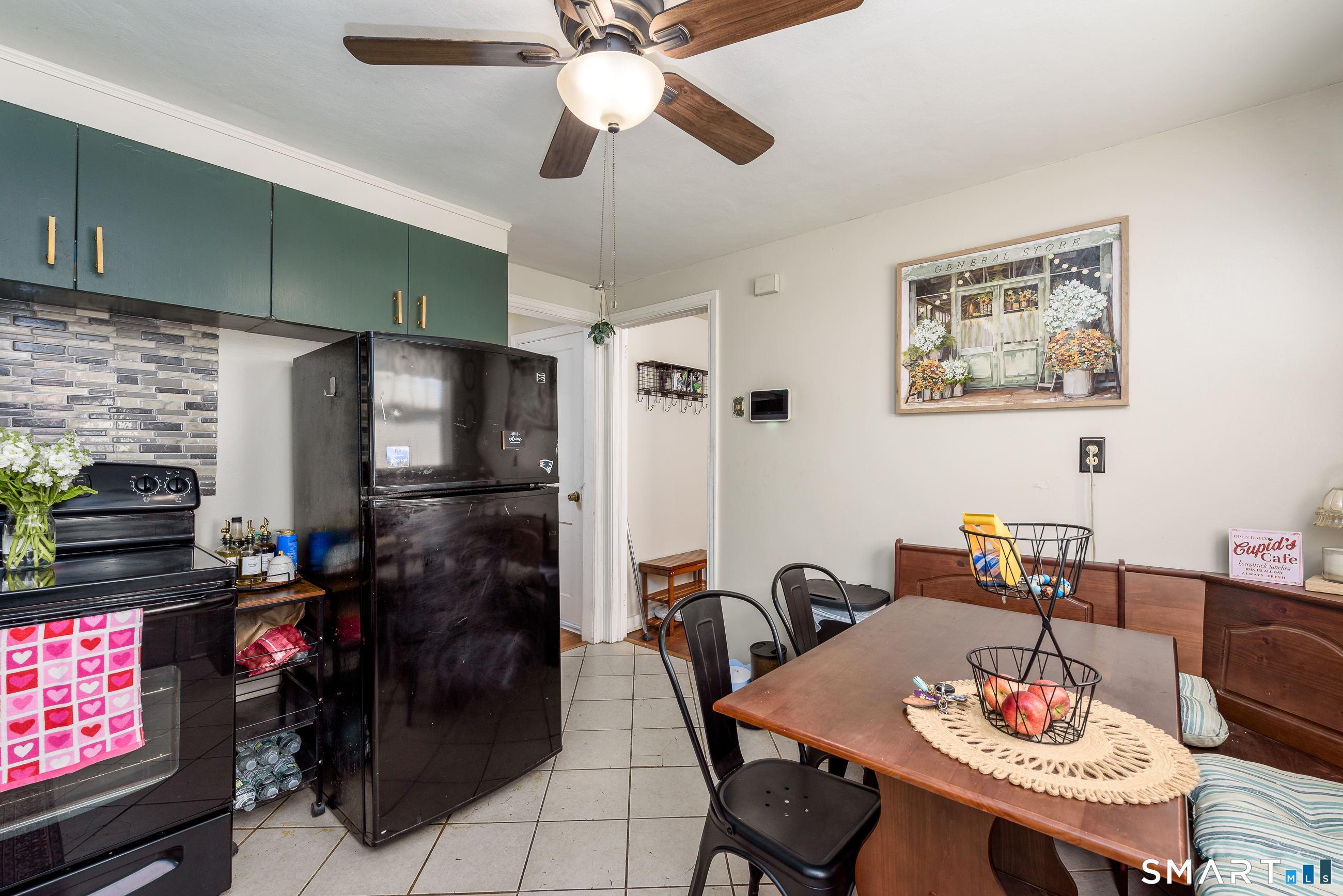 1035 North Worthy Street Windsor, CT 06095 - Photo 9 of 34 a dining room with furniture a kitchen a sink and a refrigerator