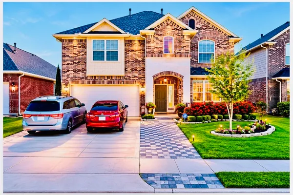 a front view of a house with a garden