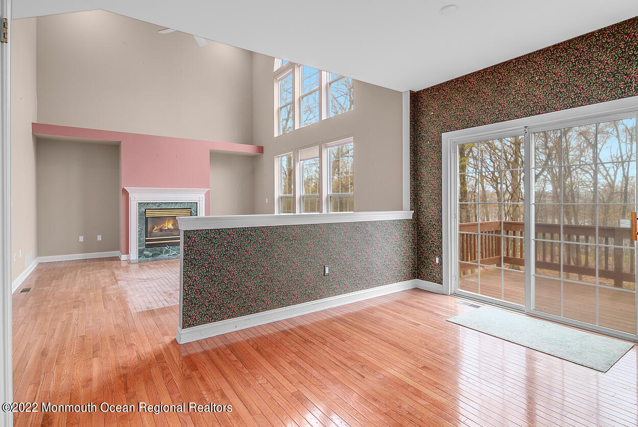 46 Glen Rock Road Cedar Grove, NJ 07009 - Photo 12 of 36 a view of empty room with wooden floor and fireplace