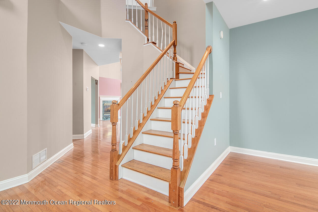 46 Glen Rock Road Cedar Grove, NJ 07009 - Photo 16 of 36 a view of staircase with wooden floor and white walls