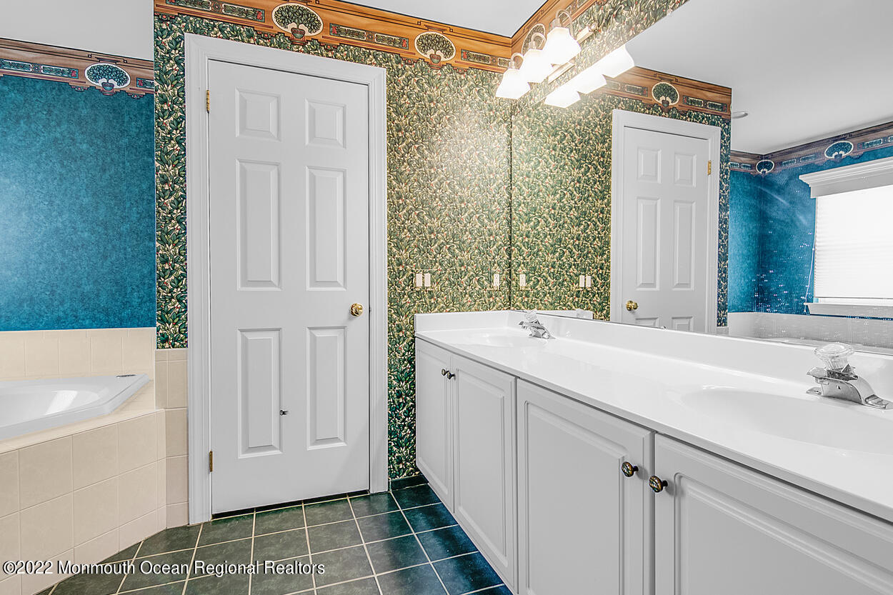 46 Glen Rock Road Cedar Grove, NJ 07009 - Photo 24 of 36 a bathroom with a sink and a mirror