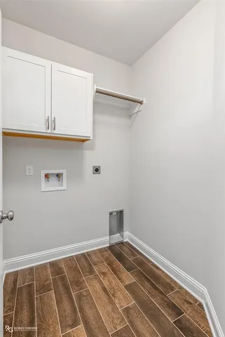 a view of a room with wooden floor and cabinet