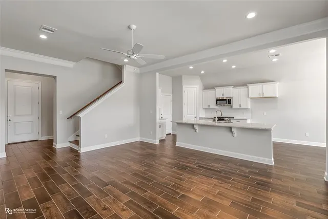 a view of kitchen with granite countertop cabinets and a sink