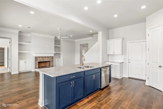 a kitchen with a sink and a stove top oven