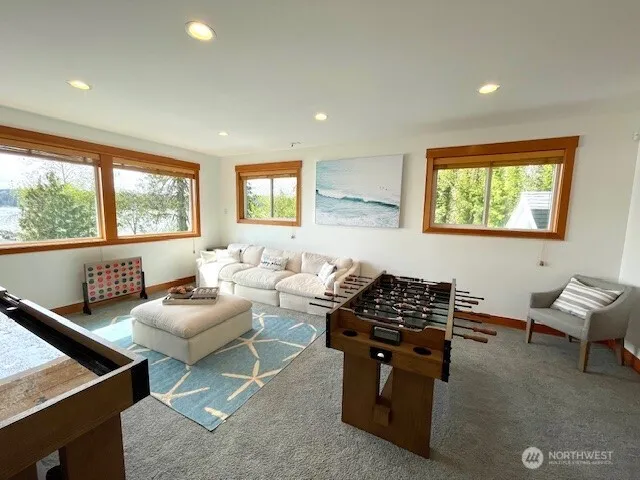 a living room with furniture a window and a flat screen tv
