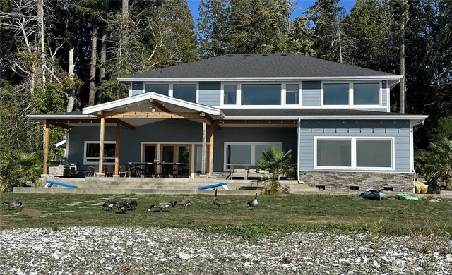 a front view of a house with a garden