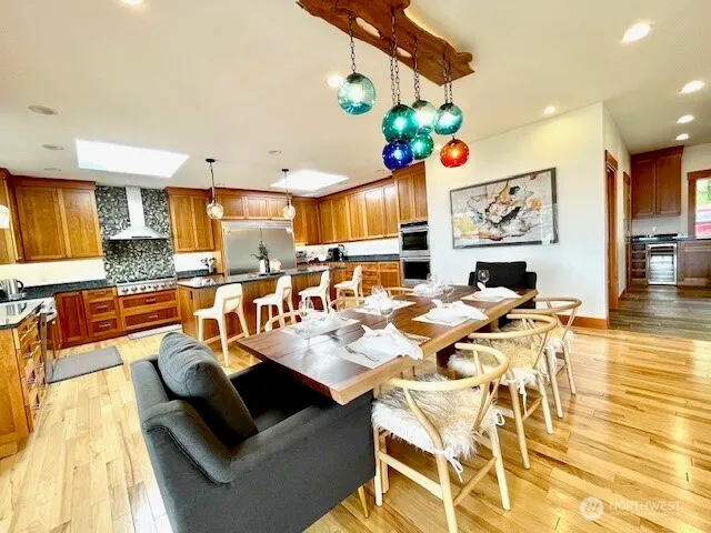 a living room with dining table and a flat screen tv