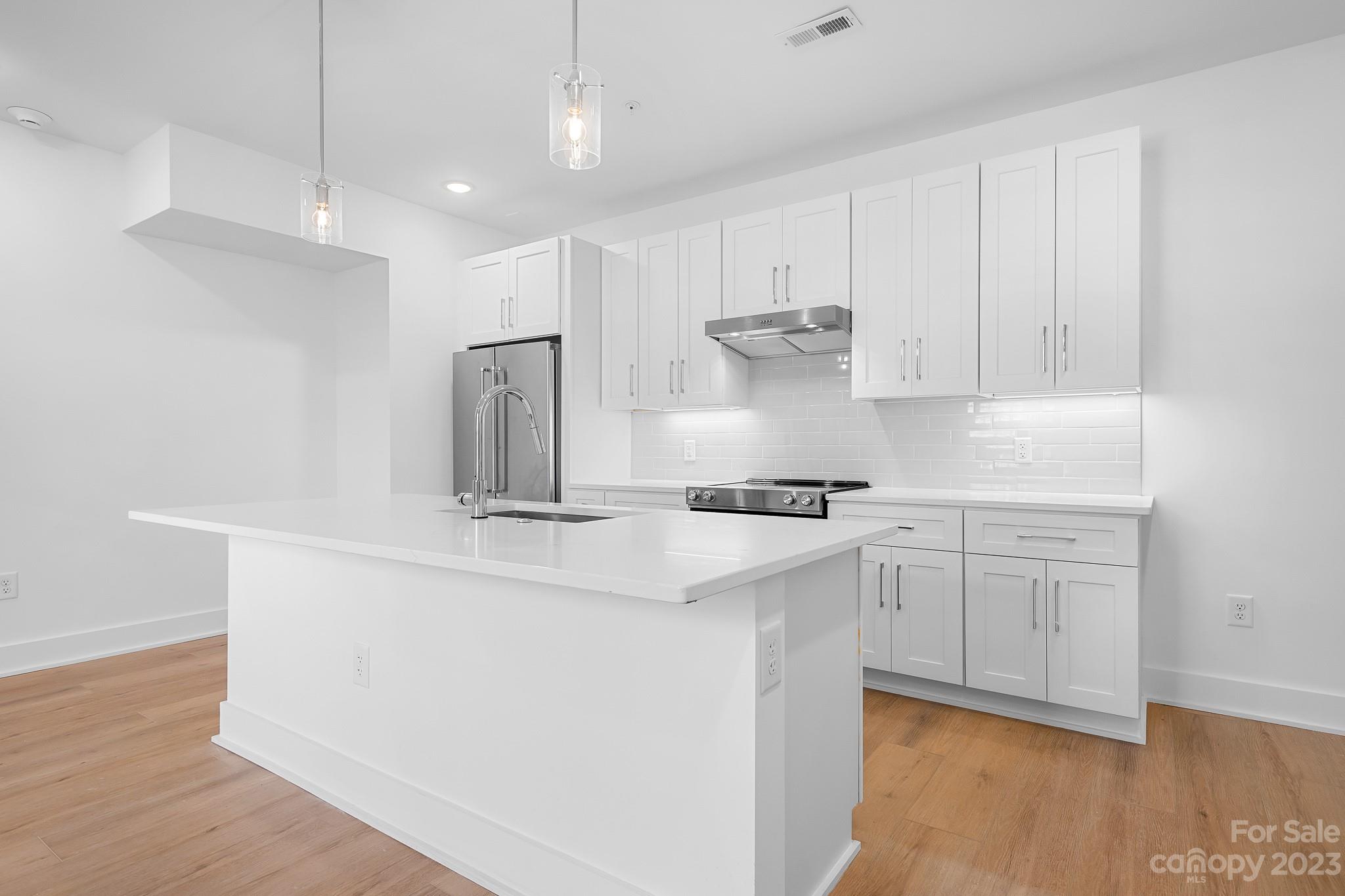 201 Grandin Road, Unit 14 Charlotte, NC 28208 - Photo 2 of 15 a kitchen with stainless steel appliances a sink a stove a refrigerator and cabinets