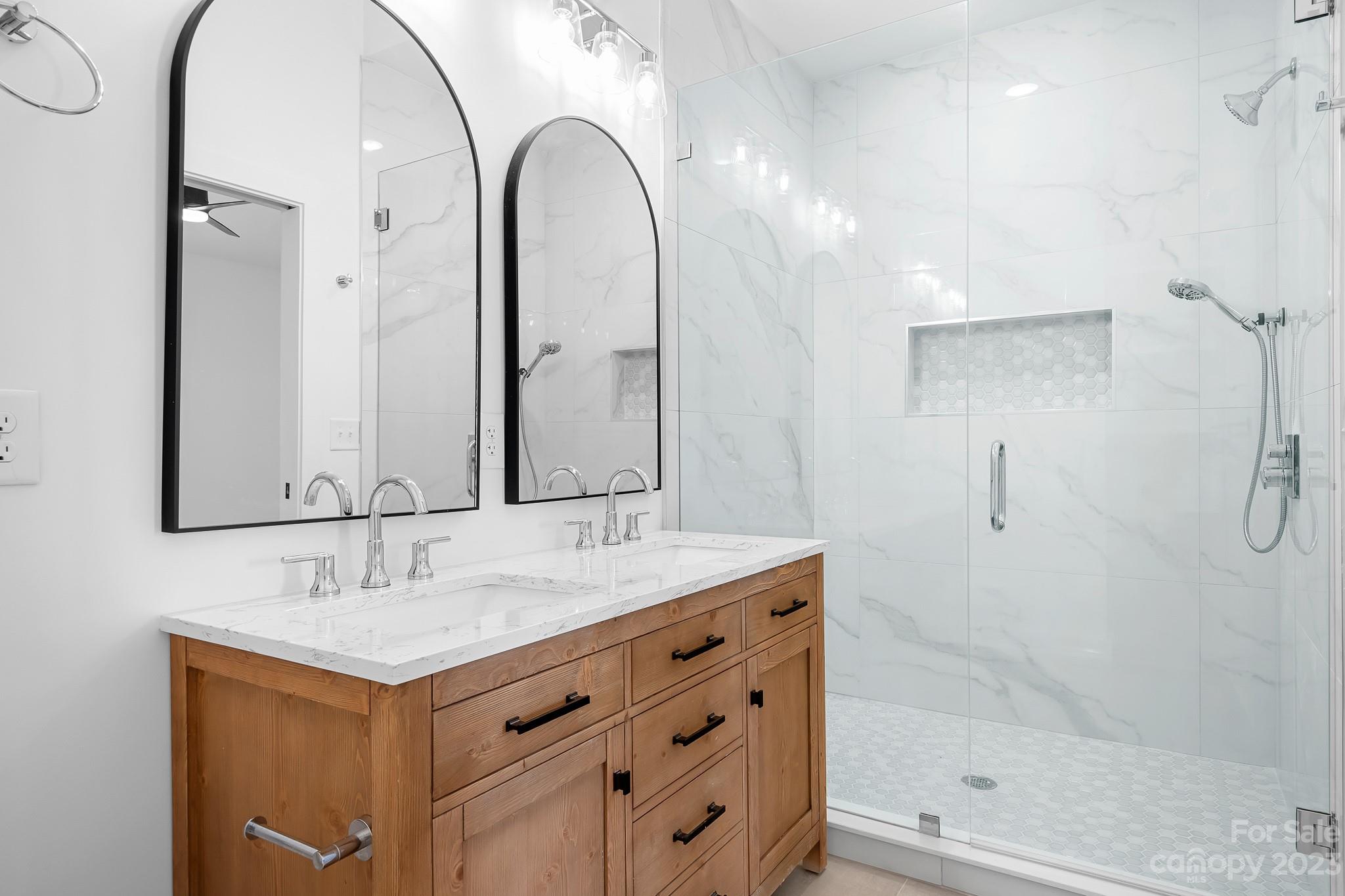 201 Grandin Road, Unit 14 Charlotte, NC 28208 - Photo 4 of 15 a bathroom with a double vanity sink mirror and shower