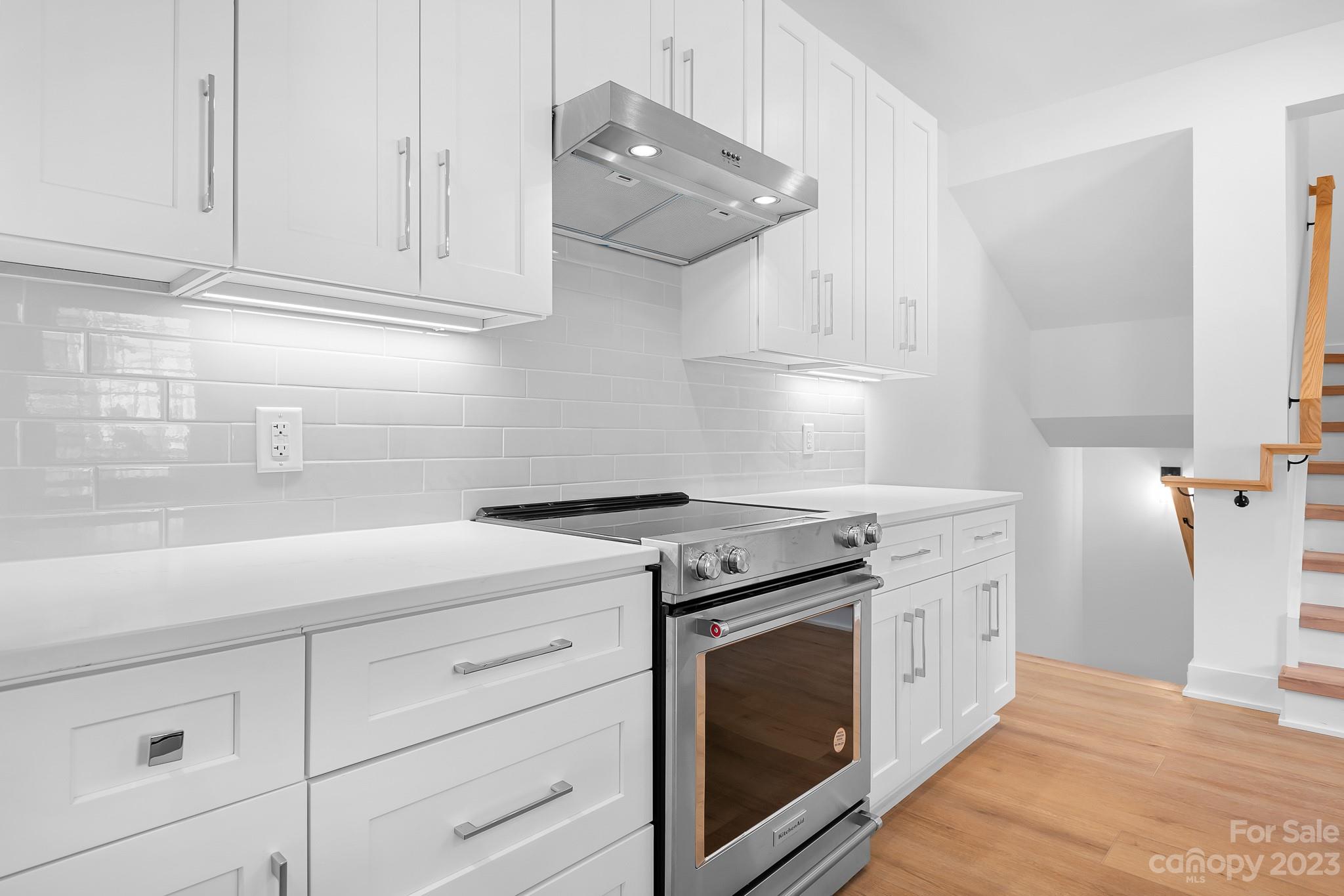 201 Grandin Road, Unit 14 Charlotte, NC 28208 - Photo 6 of 15 a kitchen with cabinets appliances and a wooden floor