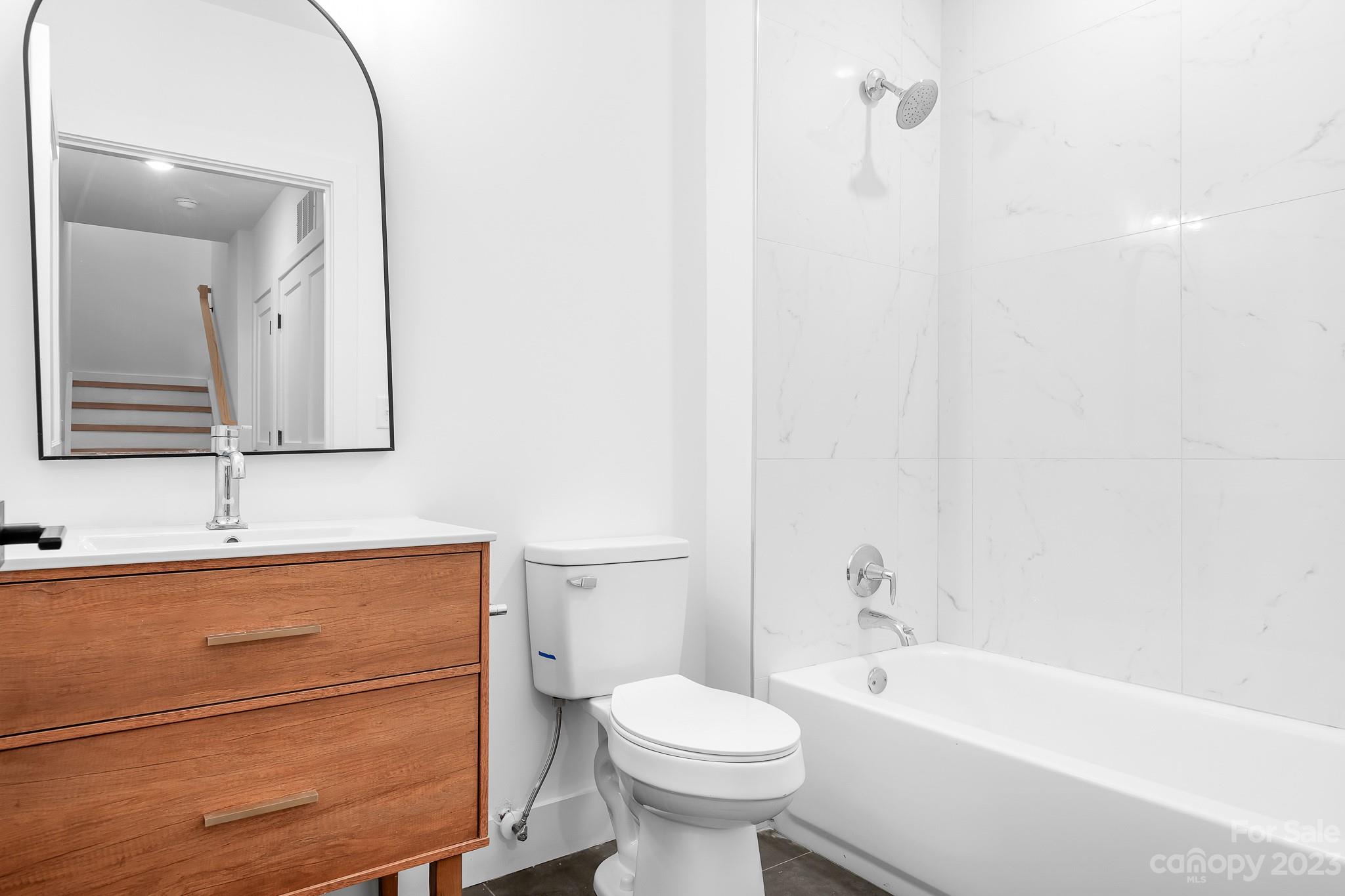 201 Grandin Road, Unit 14 Charlotte, NC 28208 - Photo 10 of 15 a bathroom with a sink a toilet and shower