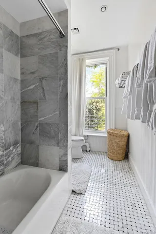 a bedroom with bed and a night stand