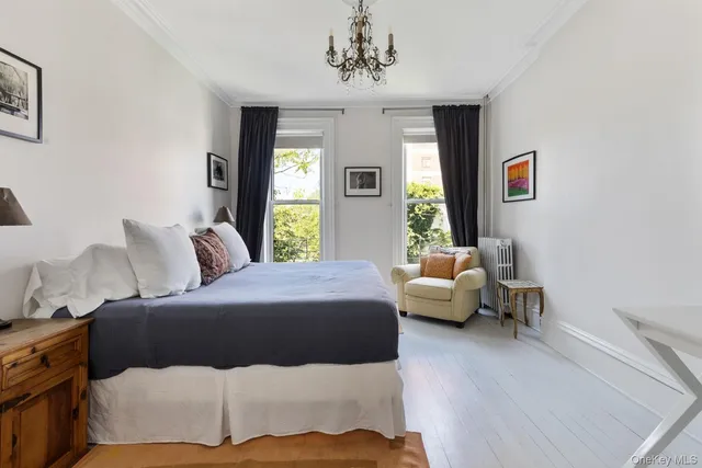 a bedroom with a bed couch and a window