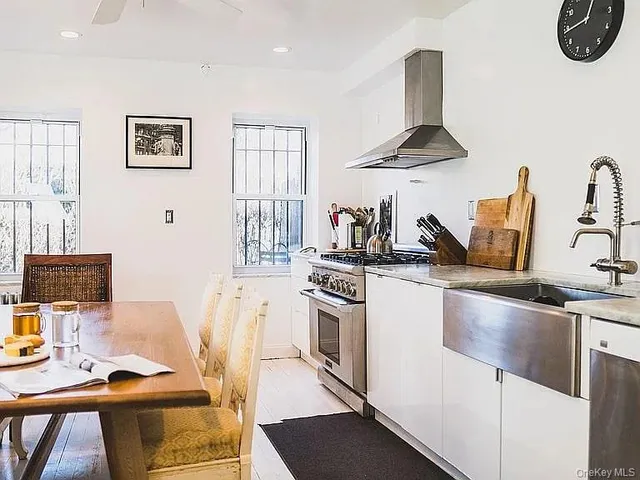 a view of a dining room and kitchen with furniture and a fireplace