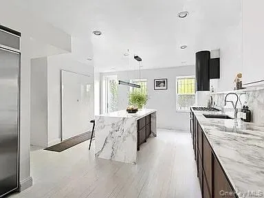 a living room with furniture a flat screen tv and a chandelier