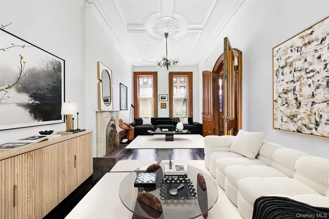 a backyard of a house with table and chairs in a forest