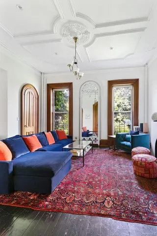 a living room with furniture and a floor to ceiling window