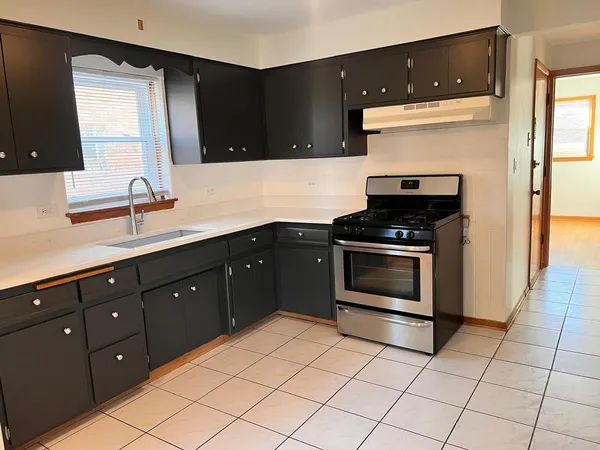 a kitchen with a sink and a stove