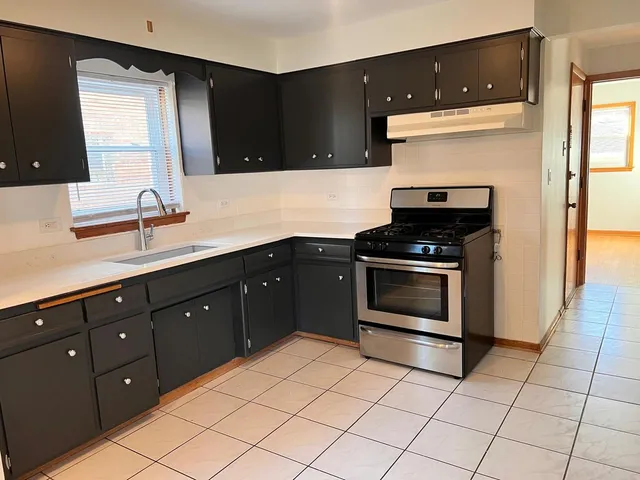 a kitchen with a sink and a stove