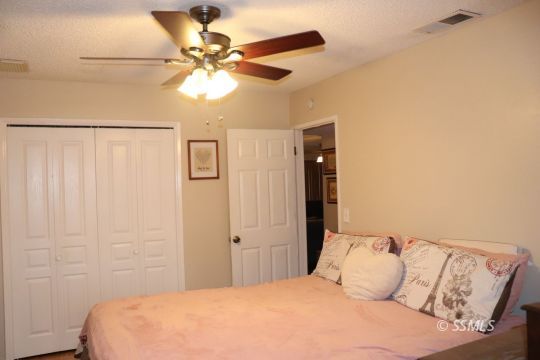 1624 South Farragut Street Ridgecrest, CA 93555 - Photo 23 of 43 a bedroom with a bed and a ceiling fan