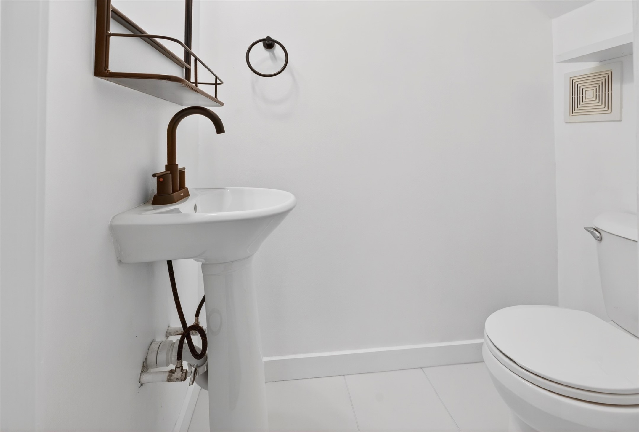 2716 Bagby Street Houston, TX 77006 - Photo 21 of 29 a bathroom with a sink a toilet and mirror