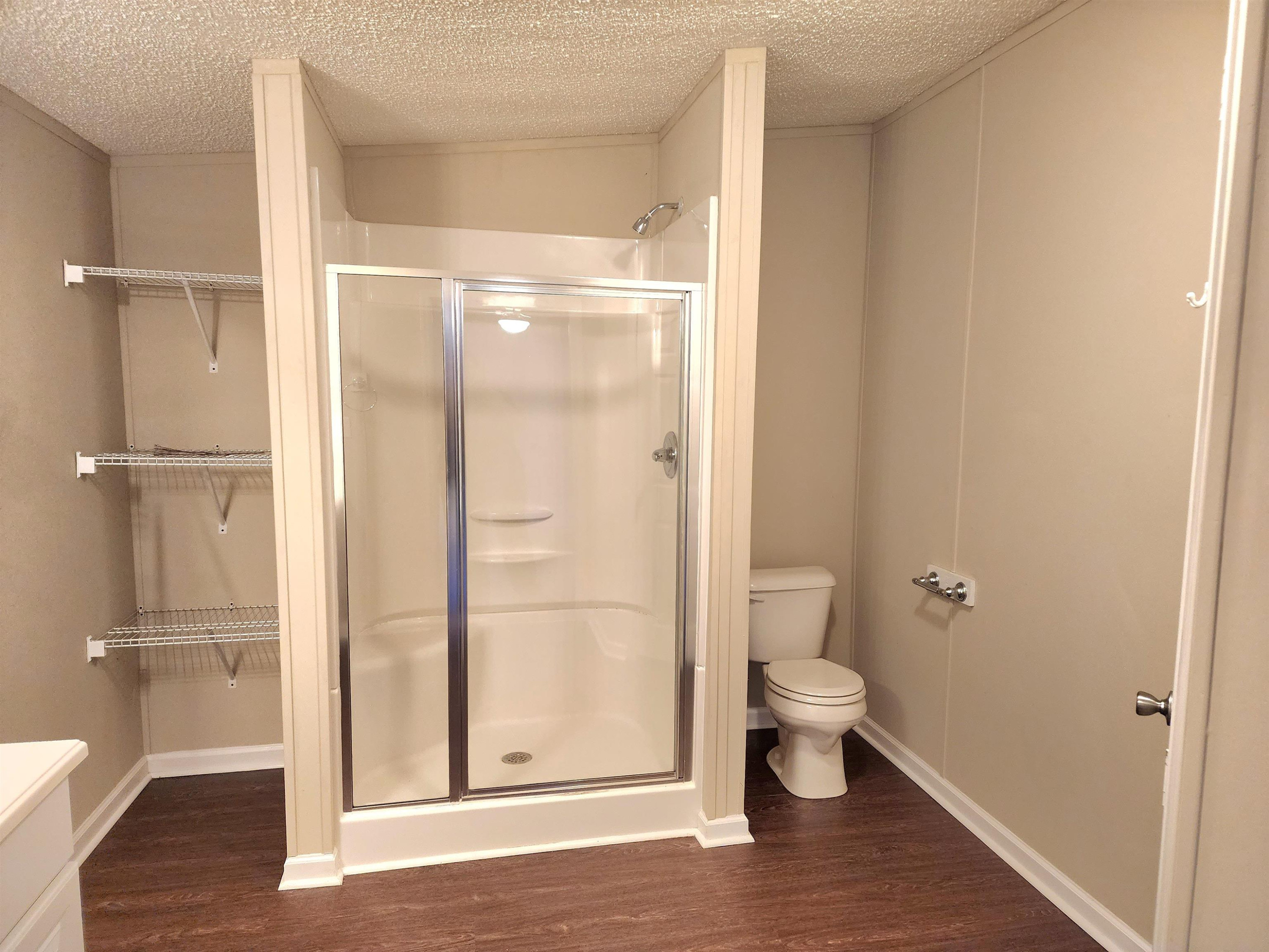 8333 Creek Road Willow Spring, NC 27592 - Photo 18 of 58 a bathroom with a glass shower door
