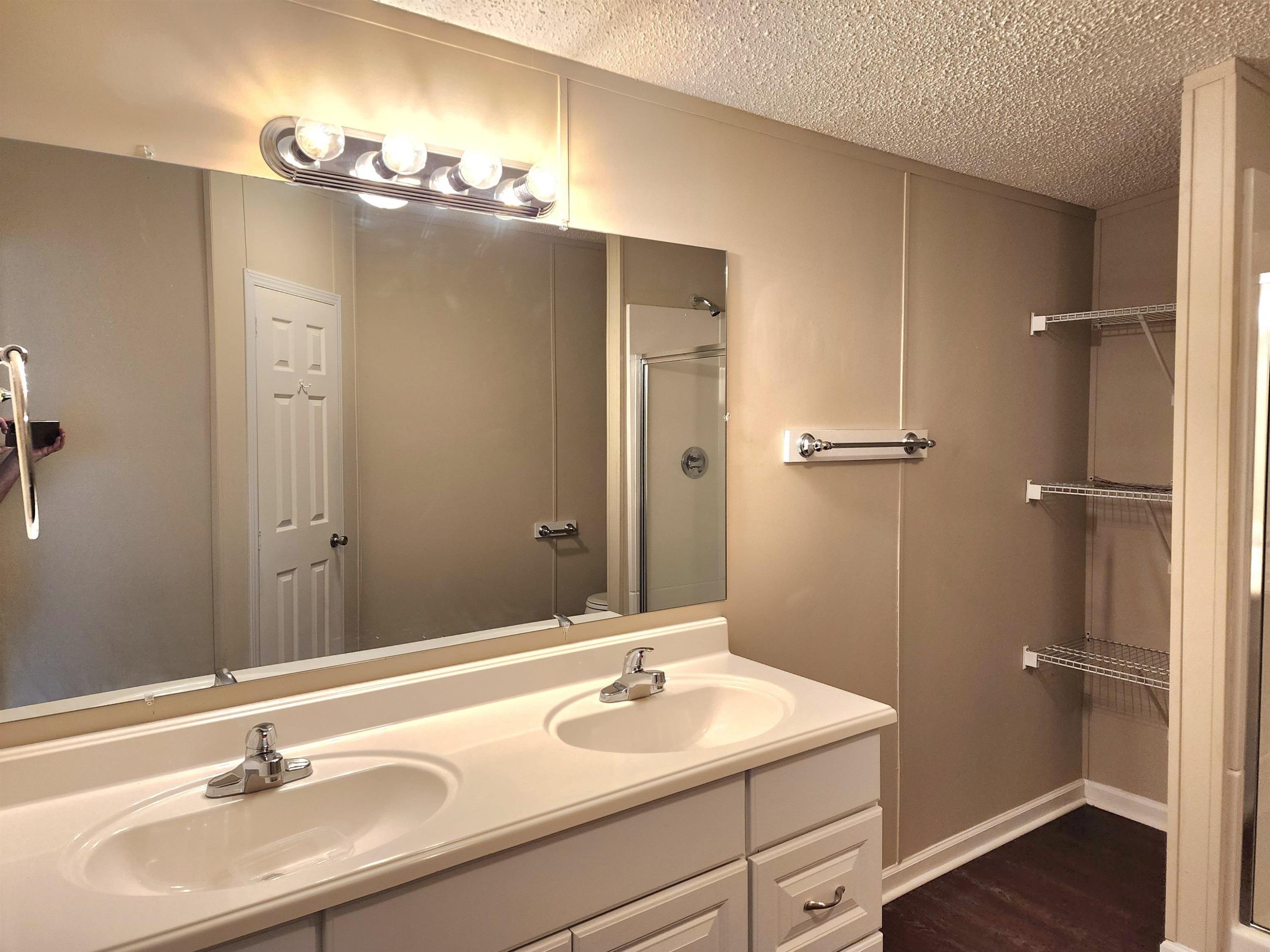8333 Creek Road Willow Spring, NC 27592 - Photo 20 of 58 a bathroom with a sink and a mirror