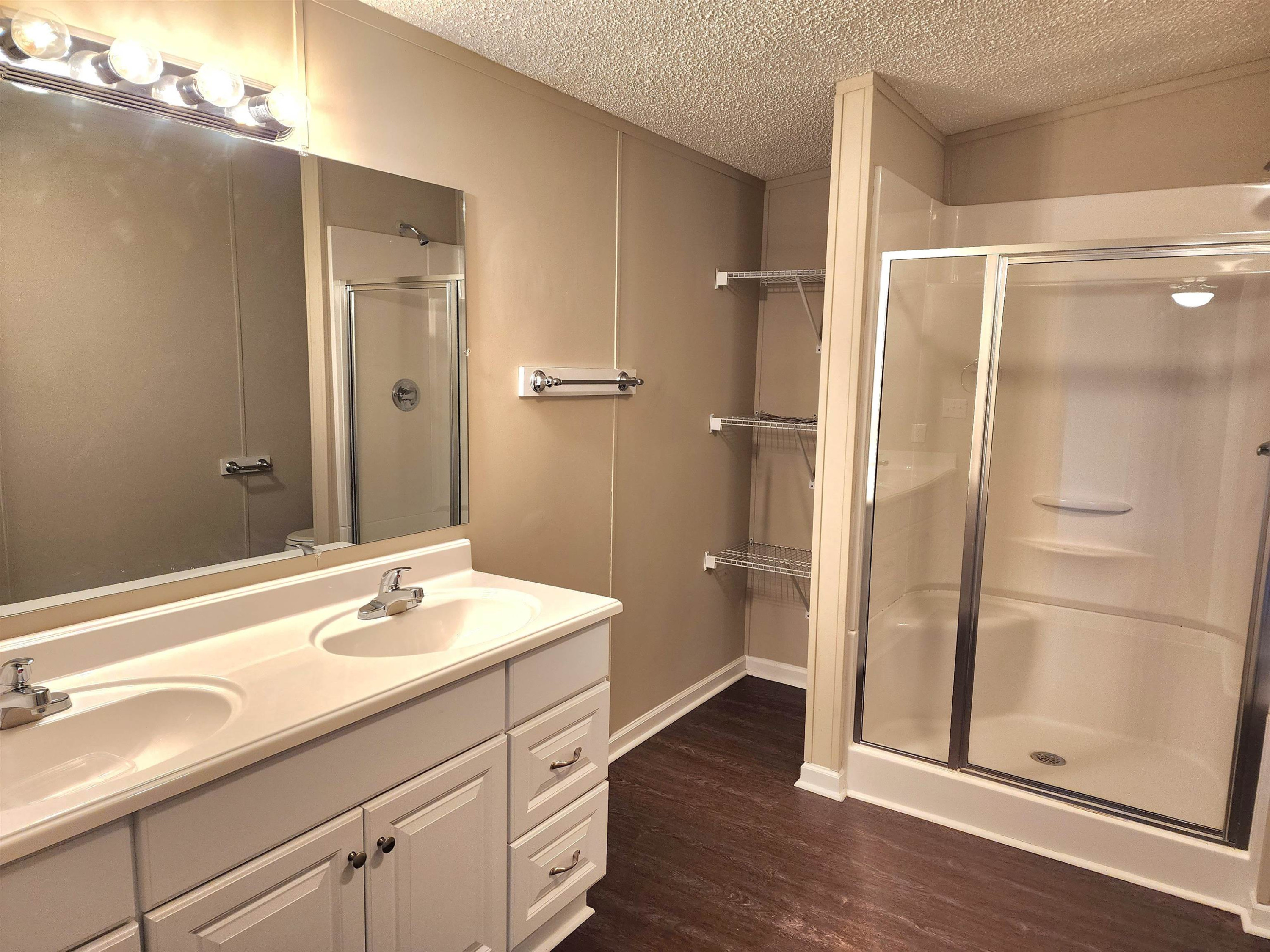 8333 Creek Road Willow Spring, NC 27592 - Photo 21 of 58 a bathroom with a shower sink and mirror