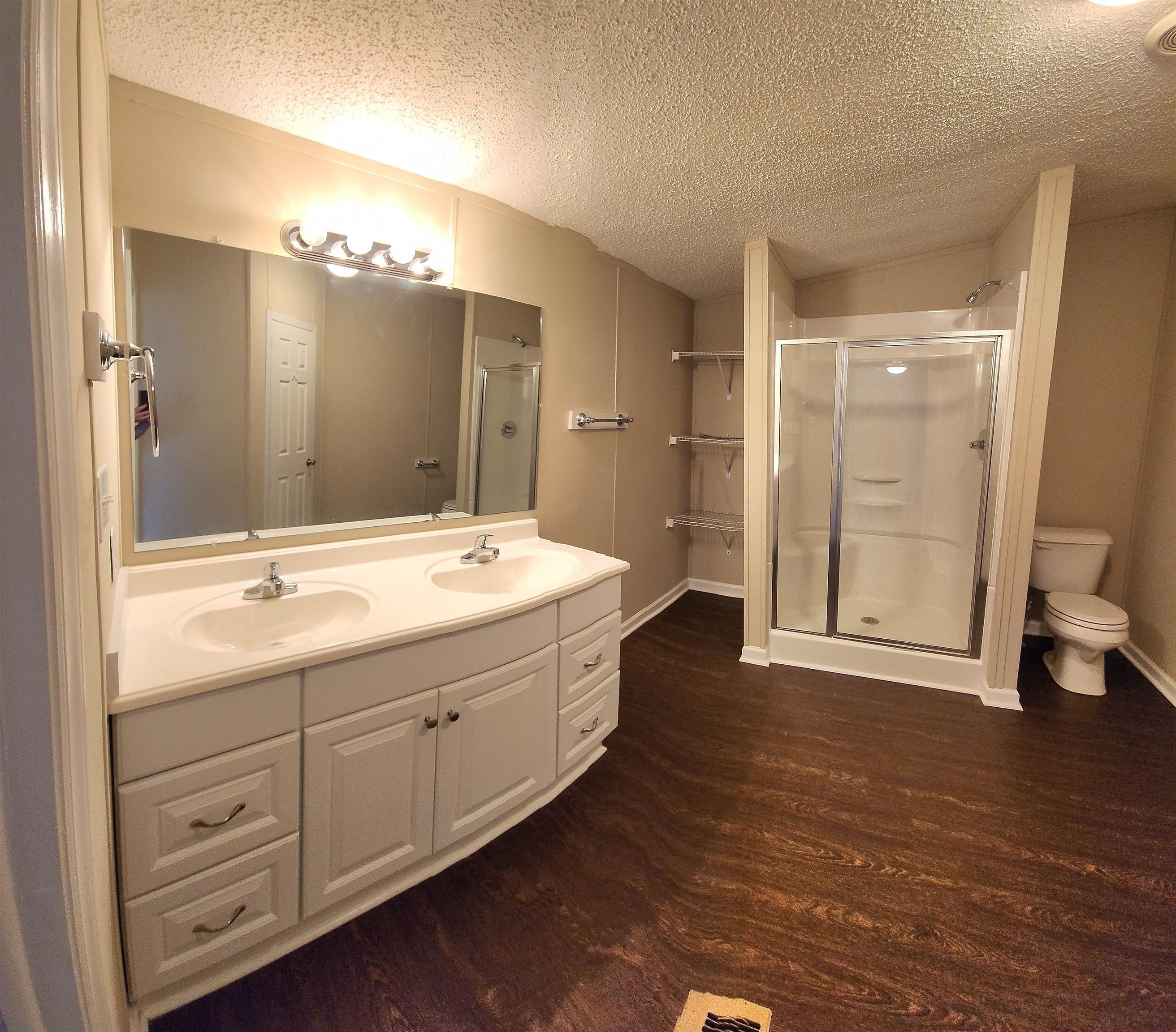 8333 Creek Road Willow Spring, NC 27592 - Photo 23 of 58 a bathroom with a double vanity sink mirror and toilet