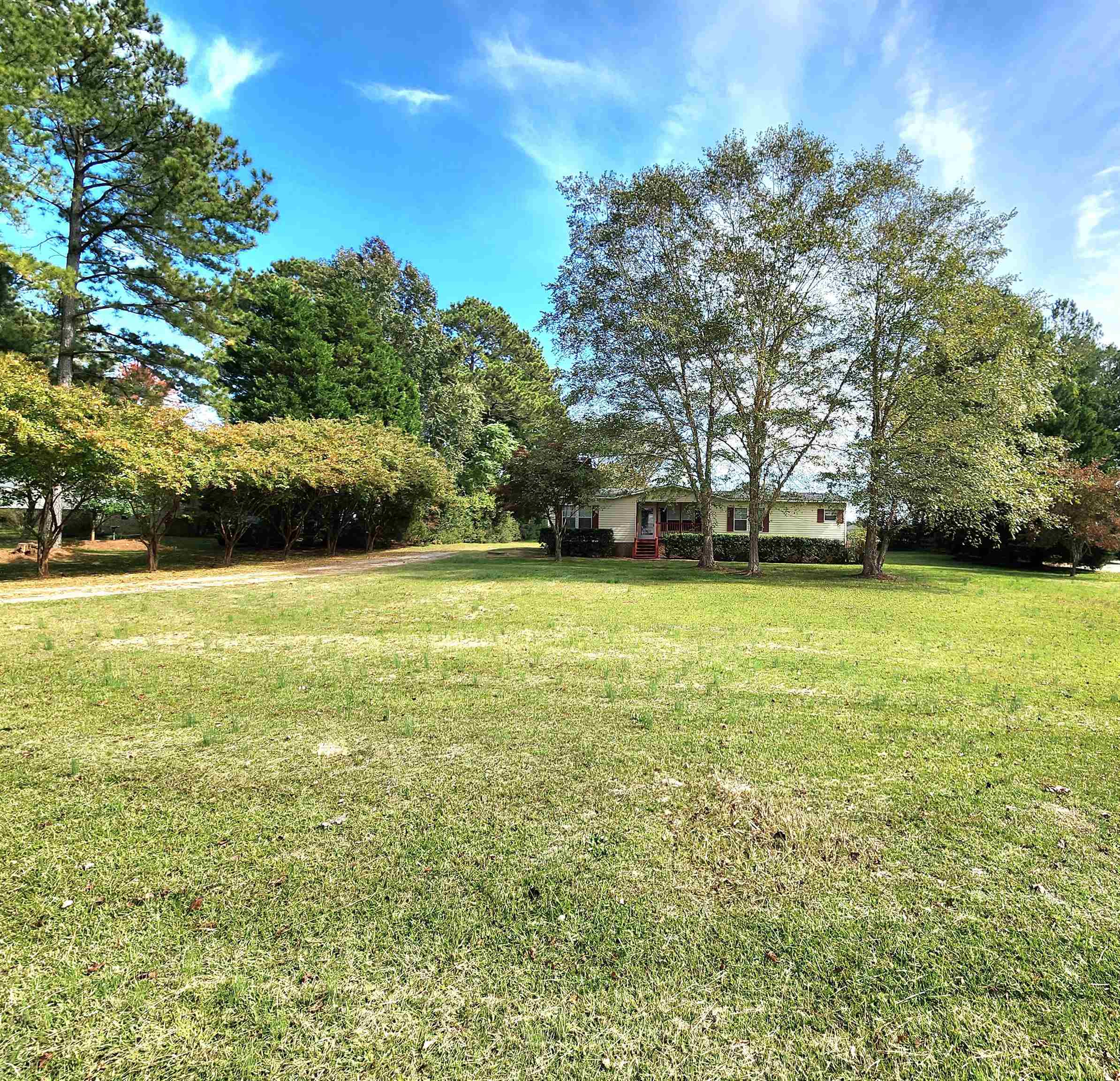 8333 Creek Road Willow Spring, NC 27592 - Photo 3 of 58 a view of a swimming pool and trees in the background
