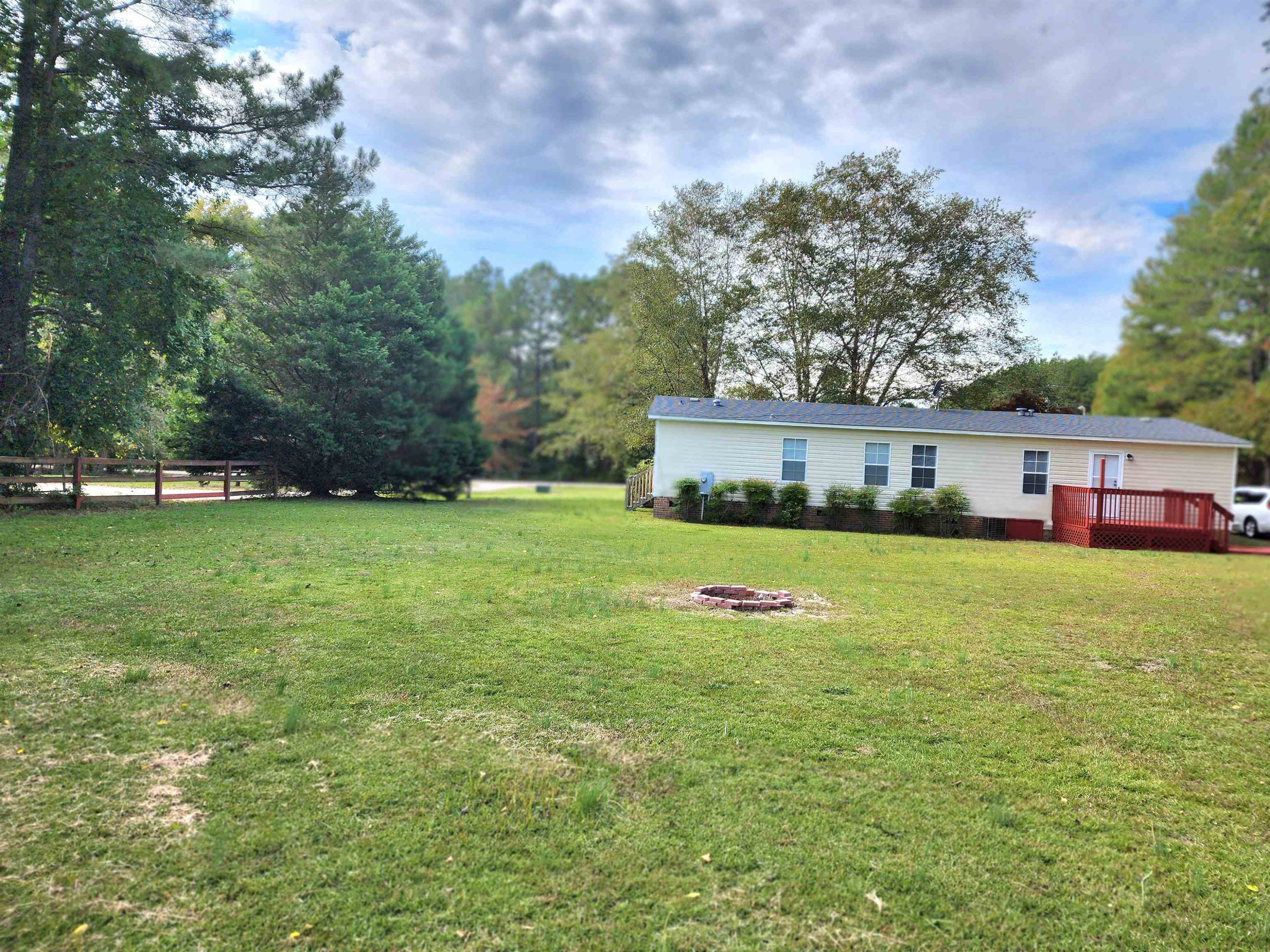 8333 Creek Road Willow Spring, NC 27592 - Photo 46 of 58 a front view of a house with a yard and trees