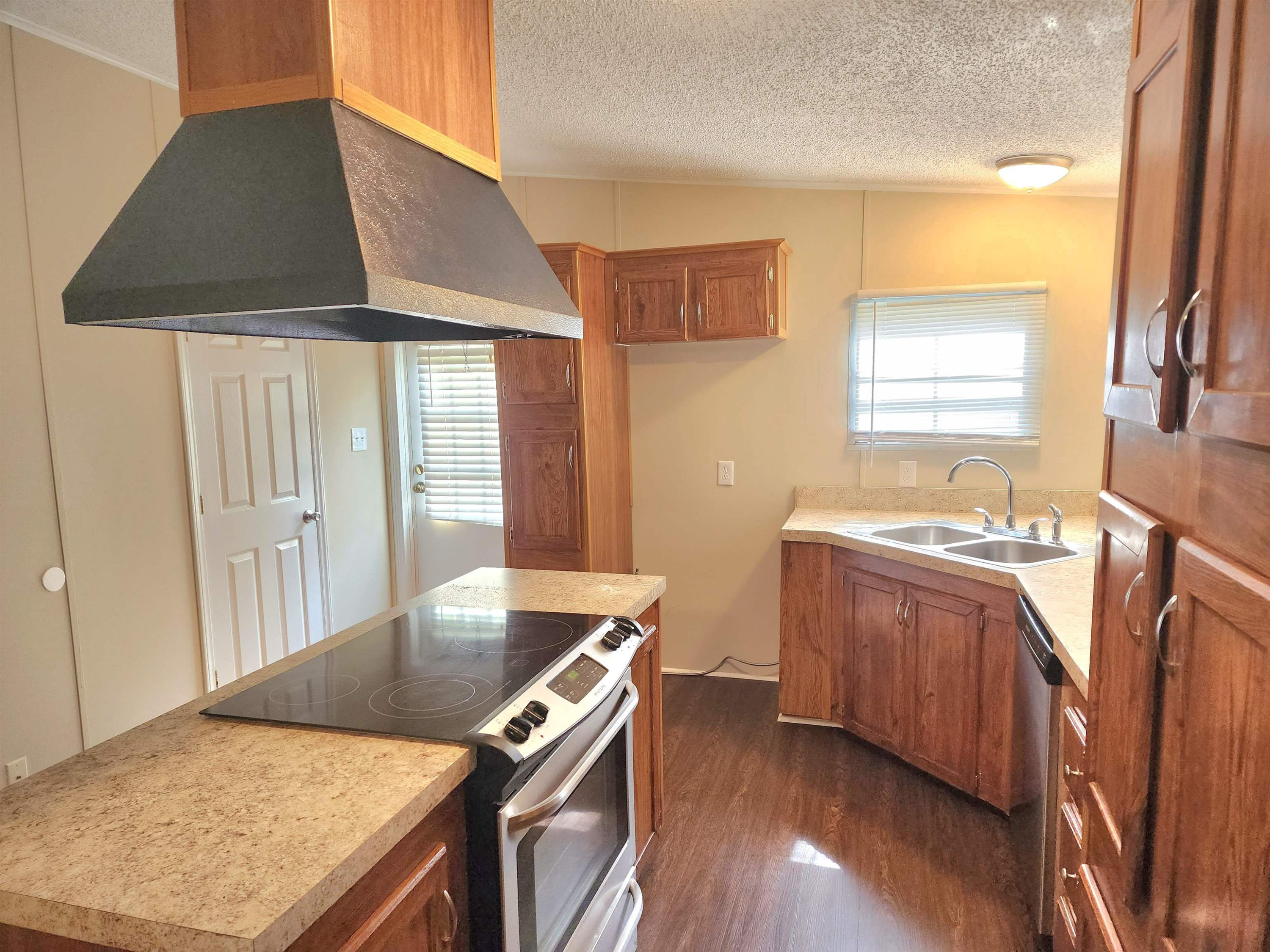 8333 Creek Road Willow Spring, NC 27592 - Photo 8 of 58 a kitchen with stainless steel appliances granite countertop a stove a sink and a refrigerator