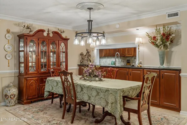 a view of a dining room with furniture and a chandelier