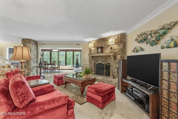 a living room with furniture a flat screen tv and a fireplace