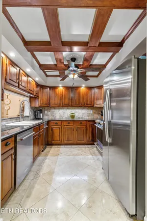 a large kitchen with cabinets and stainless steel appliances