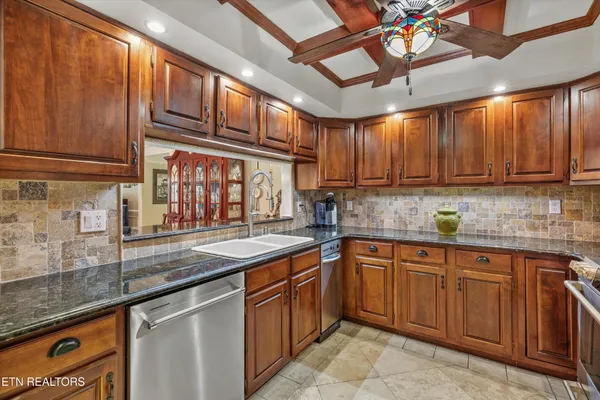 a kitchen with stainless steel appliances granite countertop a sink and cabinets