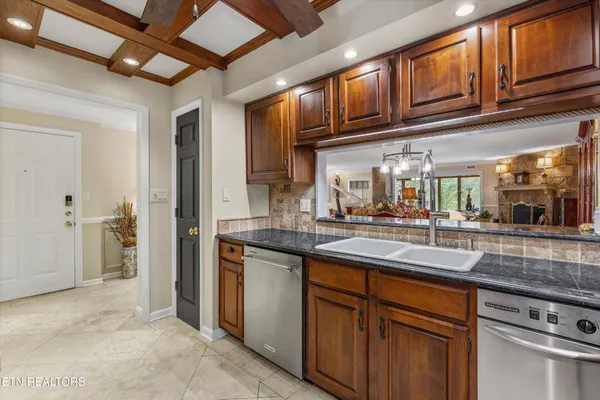 a kitchen with stainless steel appliances granite countertop a sink stove and cabinets