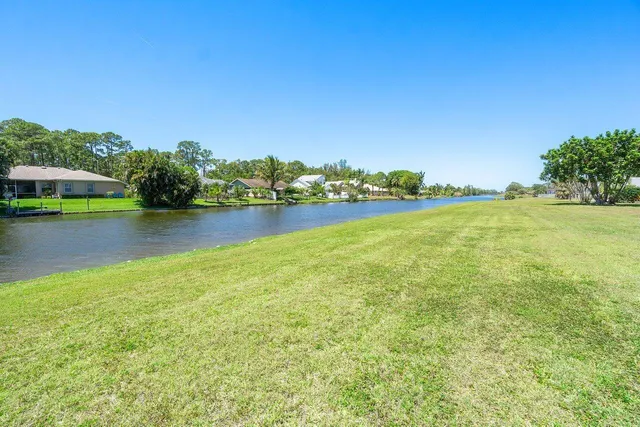 a swimming pool with outdoor seating and yard