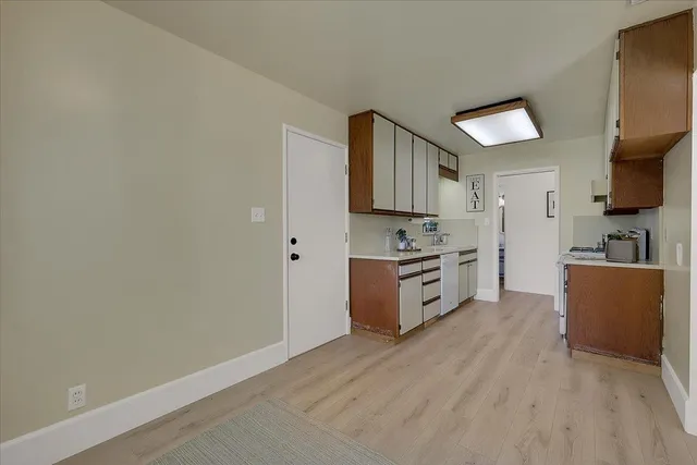 a kitchen with stainless steel appliances a refrigerator and a stove top oven