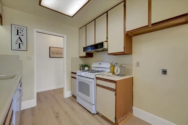 a kitchen with stainless steel appliances granite countertop a stove and a refrigerator