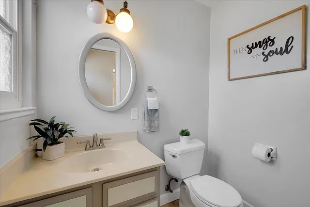 a bathroom with a toilet sink and mirror