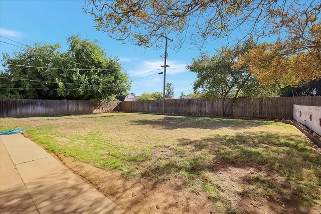 a swimming pool with outdoor seating and yard