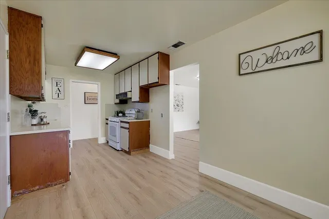 a kitchen with stainless steel appliances a refrigerator and a stove top oven